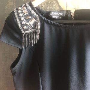 B E B E | black woman’s peplum shirt.